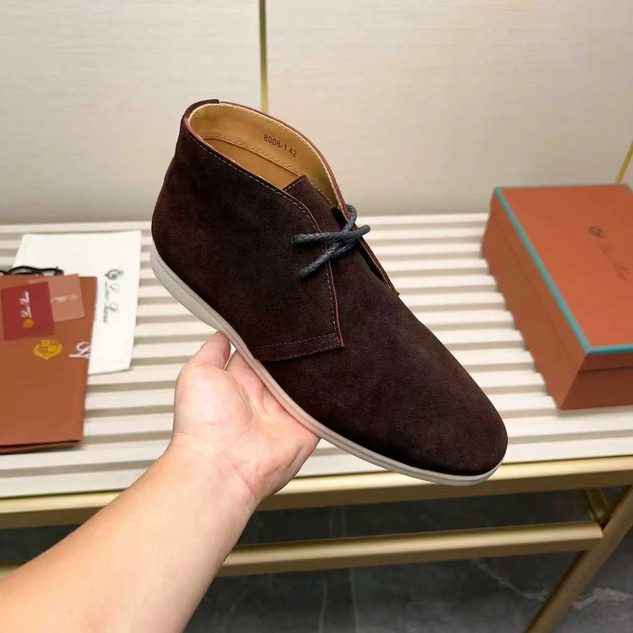 Men's Shoes 💰420 Loro Piana reimagines the desert boot—a modern, comfortable interpretation of a classic 1940s style. Crafted from suede calfskin, it exudes elegance. The tight texture of suede calfskin is not only durable but also looks casual and sophisticated. Add a timeless piece to your shoe collection, harmoniously blending comfort, style and Loro Piana's heritage of craftsmanship. Acetate satin detail on the inside White sole with LP lettering for added traction Space for a personalized signature on the heel Tonal suede trim Upper: 100% cow split suede Sole: 100% Rubber lining: Cow leather